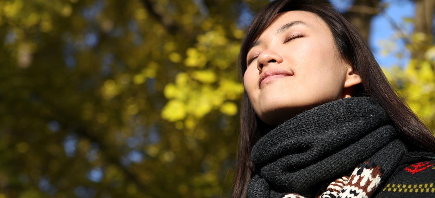 Woman in Scarf Walking Outside and Smiling