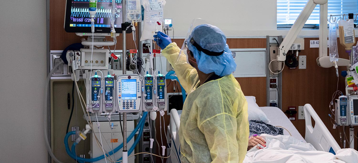 Doctor Checks on Patient with COVID-19