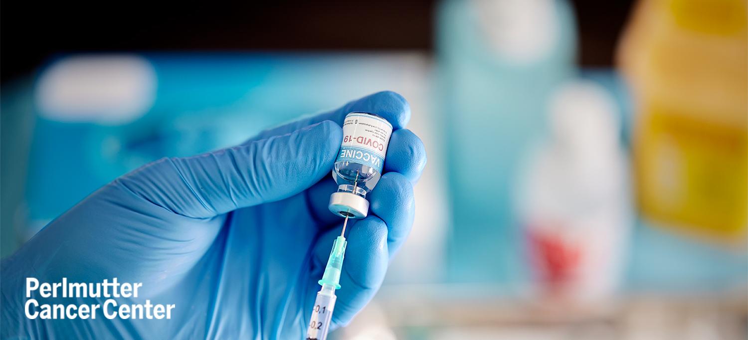 Gloved Hand Drawing Dose of COVID-19 Vaccine from Vial