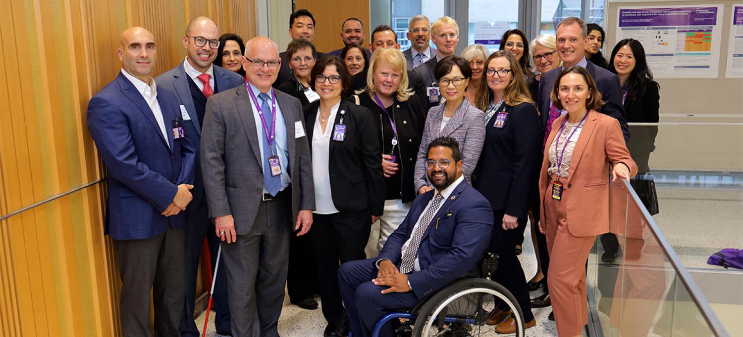 Large group of people posing together and smiling